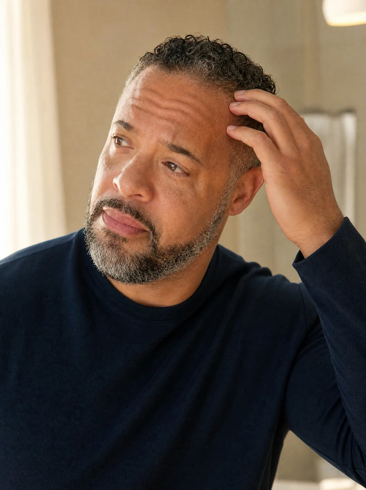 Man checking his hairline in the mirror